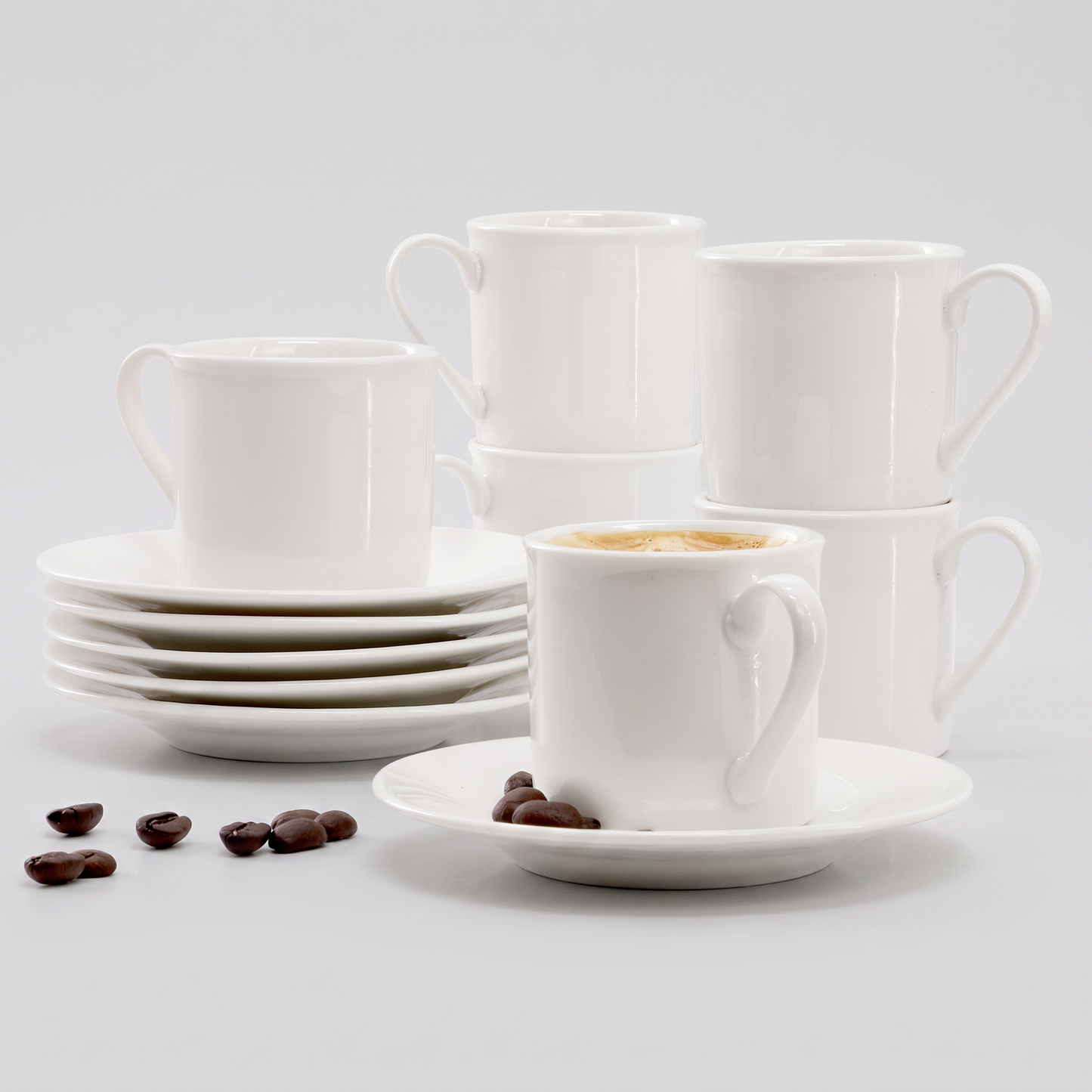 Elama Aspin 12-piece porcelain espresso cup and saucer set in white, clean studio catalog product shot on neutral gray background