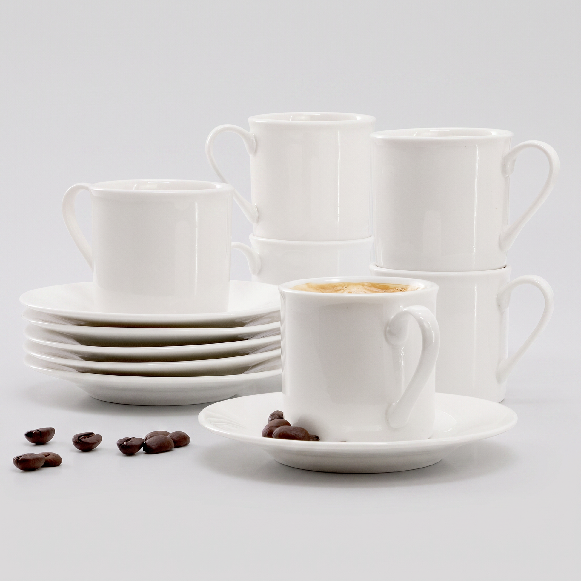 Elama Aspin 12-piece porcelain espresso cup and saucer set in white, clean studio catalog product shot on neutral gray background