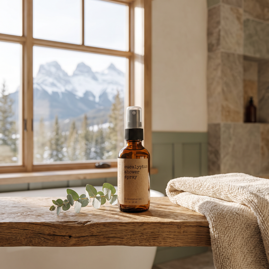 Eucalyptus shower spray staged in a mountain cabin bathroom with snow-capped peaks visible through the window