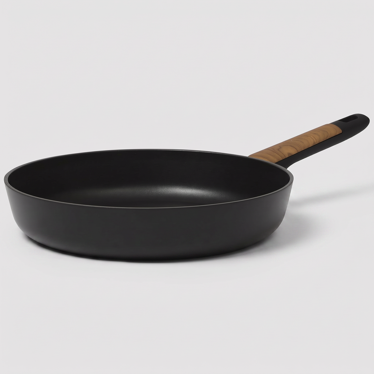 Oster Oxburg 10-inch nonstick aluminum frying pan in black, clean studio catalog product shot on neutral gray background