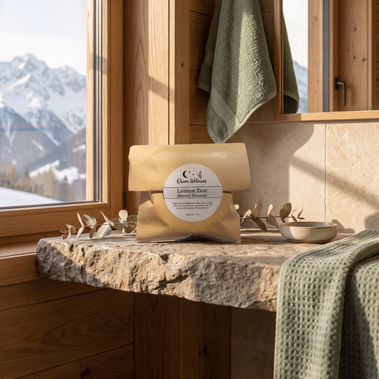 Shower Steamers staged on a stone shelf in a mountain cabin bathroom with mountain view