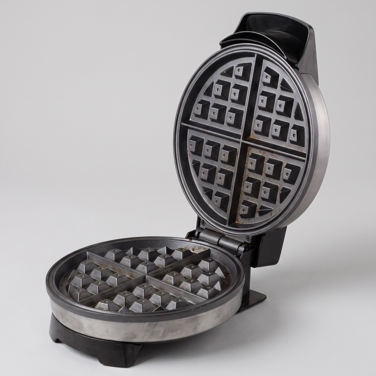 Nonstick Belgian waffle maker on a clean white studio background, product catalog photo