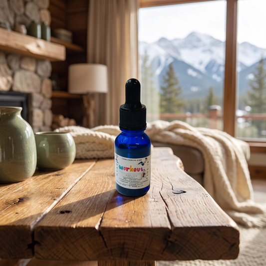 Workout essential oil blend bottle on a rustic wooden table in a cozy mountain cabin living room with a snow-capped mountain view